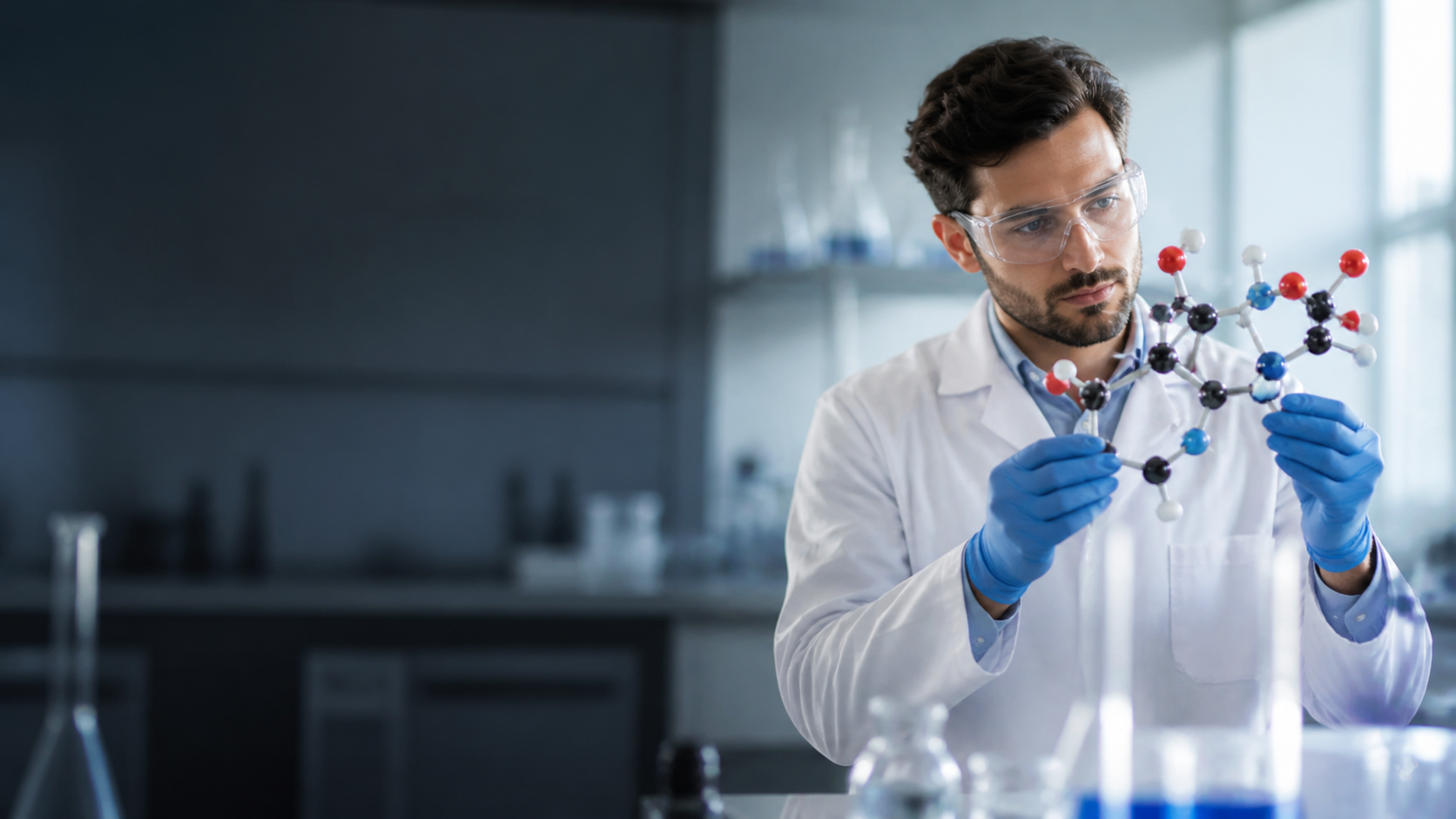 Researcher examining a molecular model in a laboratory